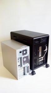 Back view of DEXTER personal computer cluster (R) and a regular tower PC (L)