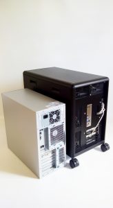 Back view of DEXTER personal computer cluster (R) and a regular tower PC (L)